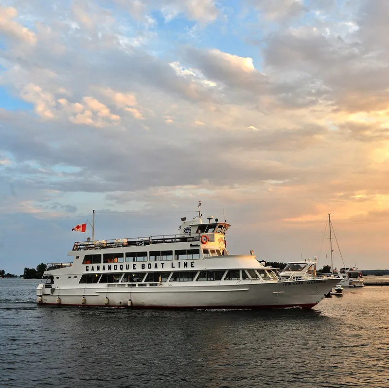 Passenger boat on a 3-hour Gananoque boat tour cruising past ocean freighters and islands on the St. Lawrence Seaway in the 1000 Islands